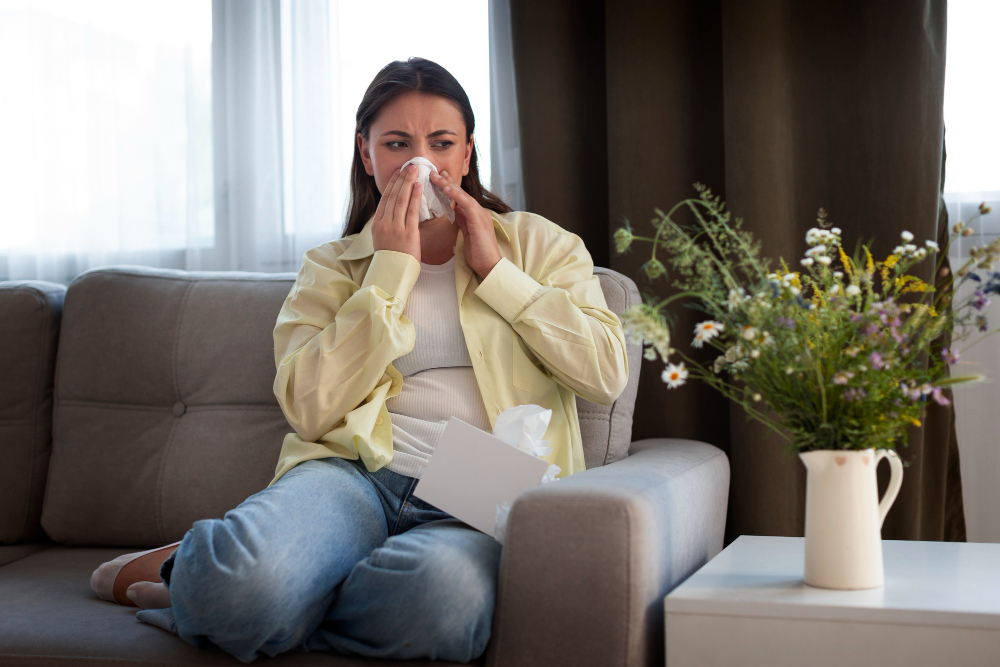 woman sneezing in living room dealing with indoor air quality issues.